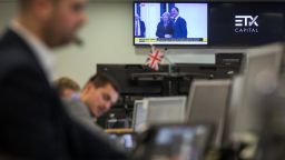 Traders monitor financial data on a trading floor in London.