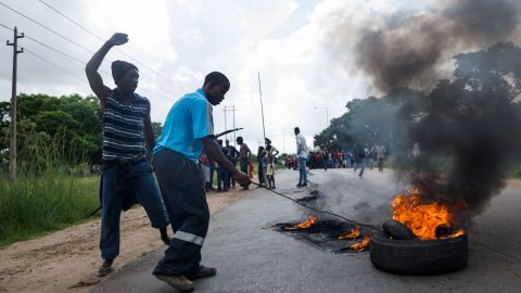 A man sets tires on fire near Zimbabwe's capital, Harare, on January 14, 2019, during protests over a large hike in fuel prices.