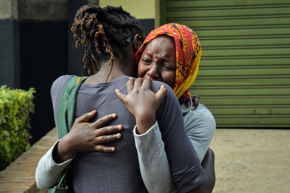 A woman cries in a relative's arms on Wednesday, January 16, while identifying bodies of victims following a deadly attack on a hotel complex in Nairobi, Kenya. Gunmen attacked the DusitD2 Hotel the day before with gunfire and explosions.