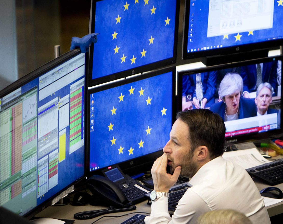 A broker watches news coverage of Brexit. 