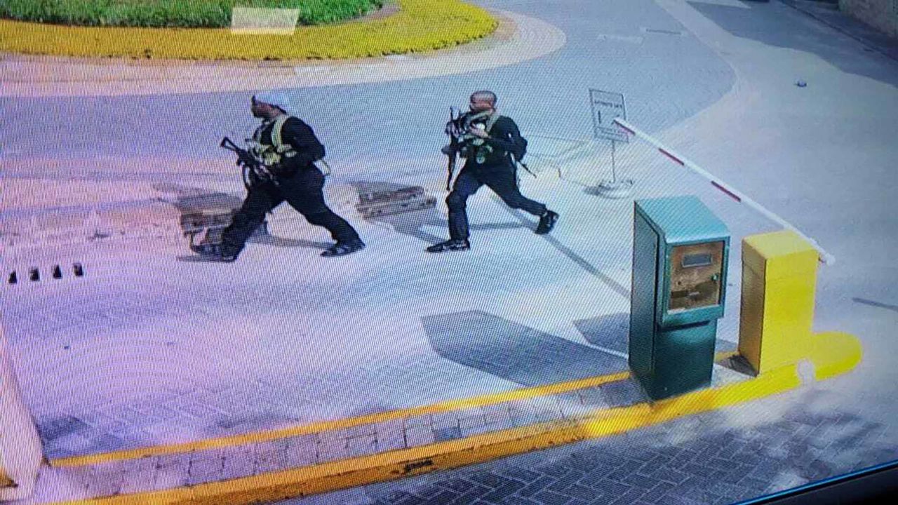 Heavily armed attackers walk through the Nairobi hotel compound in this grab taken from security camera footage released to the local media.