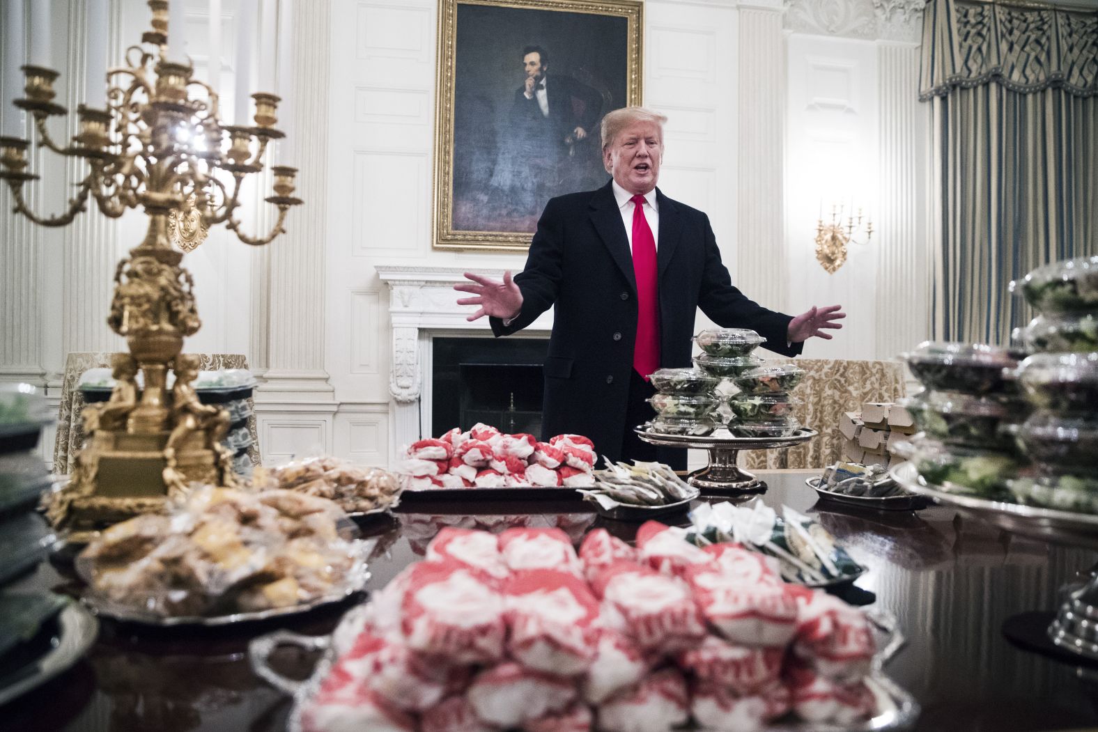 The President displays <a href="https://www.cnn.com/2019/01/14/politics/donald-trump-clemson-food/index.html" target="_blank">fast food he purchased</a> for the Clemson Tigers football team for their national championship celebration at the White House on January 14. "Because the Democrats refuse to negotiate on border security, much of the residence staff at the White House is furloughed -- so the President is personally paying for the event to be catered with some of everyone's favorite fast foods," deputy press secretary Hogan Gidley told CNN in a statement