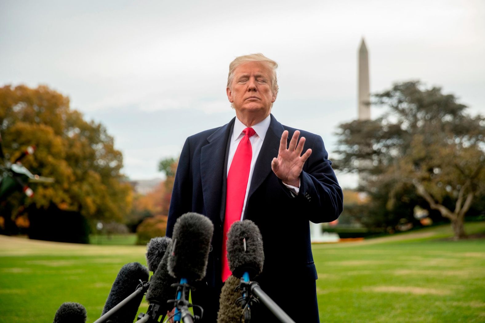 Trump waves off a reporter's question as he speaks to members of the media on the South Lawn of the White House before boarding Marine One on November 2. "What you don't see in this image are the throngs of cameramen, sound crews, photographers, reporters, Secret Service agents and White House aides all packed in together behind ropes," photographer Andrew Harnik said. "What you don't hear is the defining sound from the helicopter and dozens of reporters all shouting at the top of their lungs to be heard and get their questions answered by the President. ... Though the image was made in a loud raucous environment, the resulting image has a quiet power to it -- with his eyes closed and the wave of his hand, Trump silences a reporter's question."
