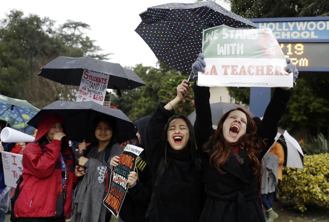 Teacher Maria Arienza, right, rallies next to student Stephanie Medrano outside North Hollywood High. 