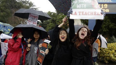 Teacher Maria Arienza, right, rallies next to student Stephanie Medrano outside North Hollywood High.