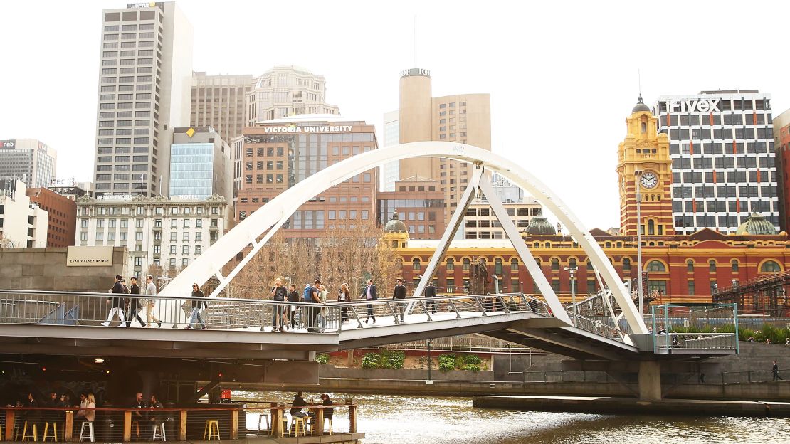 Melbourne's neighborhoods are a big selling point. Here, people cross a pedestrian bridge in popular Southbank.