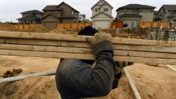DENVER, CO - AUGUST 1:  A workman carries planks of wood for a house while working on building new homes in the Beeler Park neighborhood of Stapleton on August 1, 2018, in Denver, Colorado.  Developer Forest City is about to release the first of 1,300 single-family lots just south of the Rocky Mountain Arsenal National Wildlife Refuge on land that once hosted the northern runways of Stapleton International Airport. The new Stapleton neighborhood, which is next to Beeler Park, will be called North End and is the 12th and final neighborhood for  Stapleton. A construction wave that started with Stapleton's South End neighborhood in 2001 will bookend with the North End neighborhood. Once the last home on the last street is sold, probably some time in 2021, only commercial lots will be left. (Photo by Helen H. Richardson/The Denver Post via Getty Images)