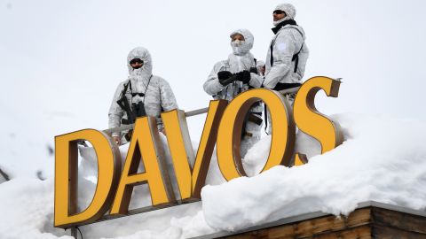 Armed security personnel stand guard on a rooftop in Davos.