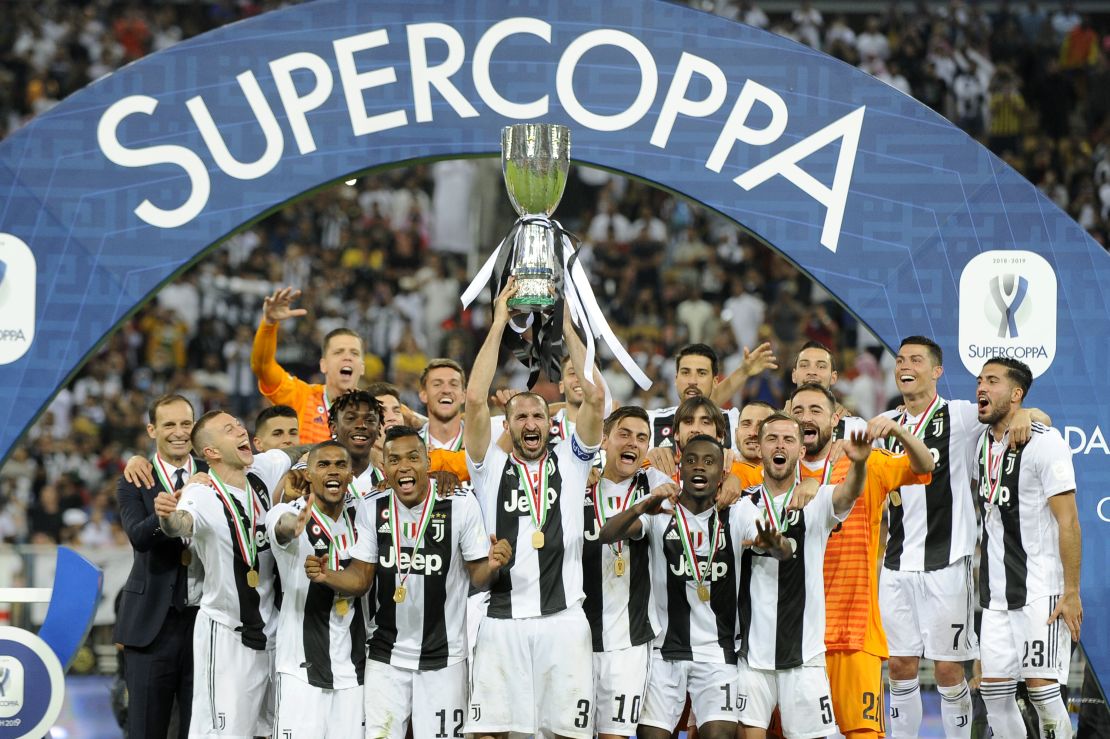 Giorgio Chiellini of Juventus lifts the trophy after winning the Italian Super Cup.