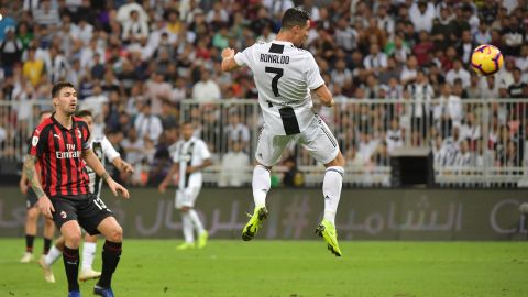 Juventus' Portuguese forward Cristiano Ronaldo heads the ball to score during their Supercoppa Italiana final between Juventus and AC Milan at the King Abdullah Sports City Stadium in Jeddah.