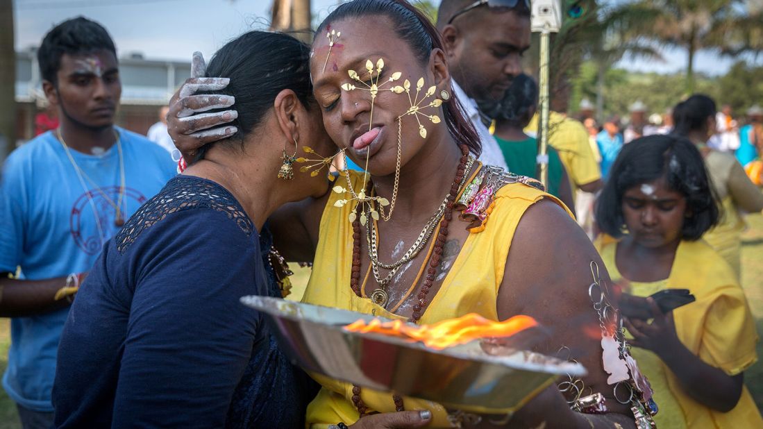 <strong>International celebrations: </strong>Celebrations take place in Tamil communities around the world. This Hindu woman, her body pierced with spikes, flowers and lime, was taking part in a procession at the Shree Emperumal Hindu Temple in South Africa.