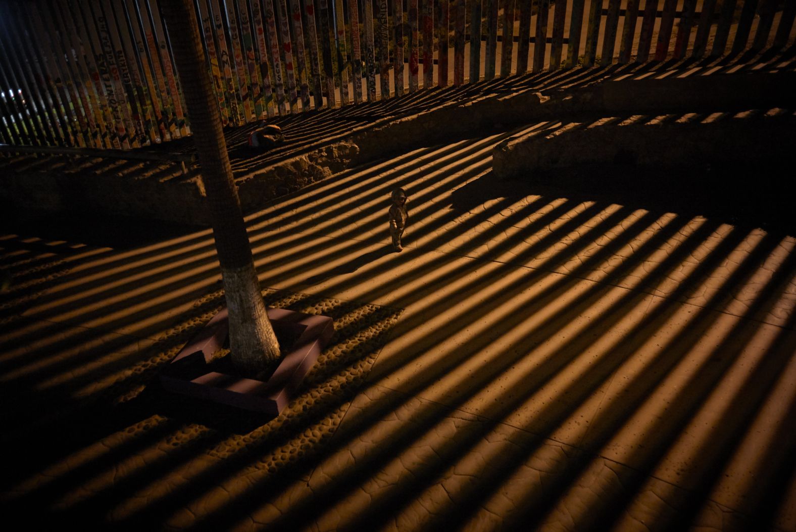 A child plays along the border wall in Tijuana, Mexico, on Friday, January 11.