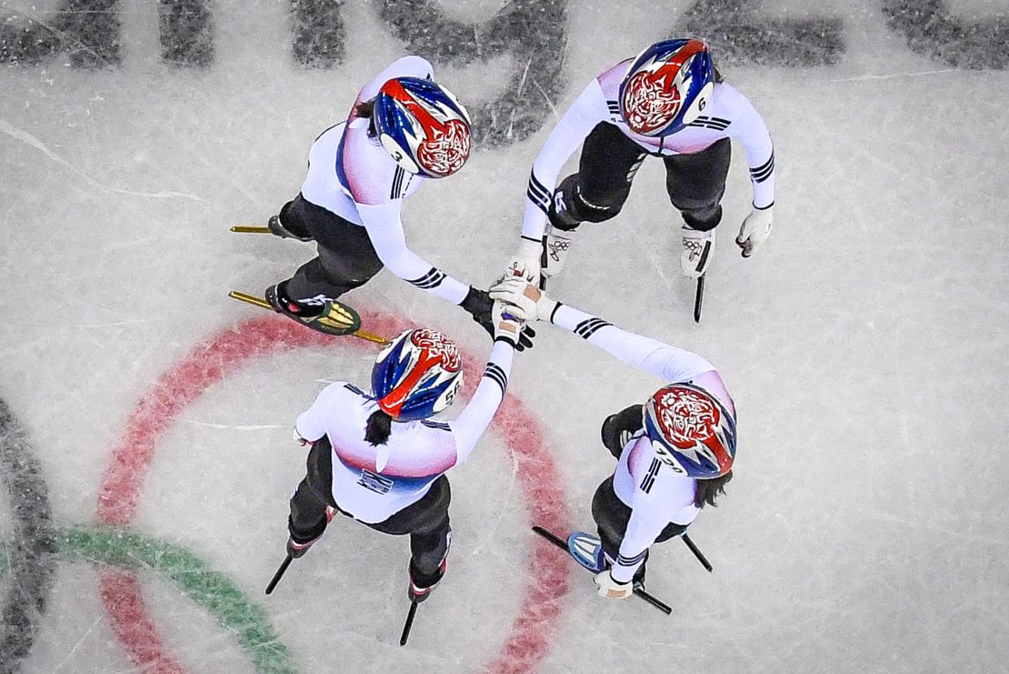 The South Korea team hold hands before winning the women's 3,000m relay short track speed skating heat event during the Pyeongchang 2018 Winter Olympic Games.