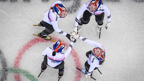 The South Korea team hold hands before winning the women's 3,000m relay short track speed skating heat event during the Pyeongchang 2018 Winter Olympic Games.