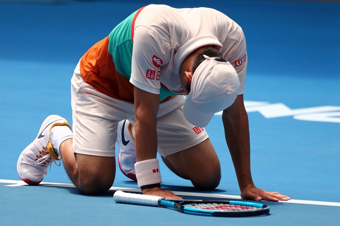 Kei Nishikori dropped to the court in joy after beating Ivo Karlovic at the Australian Open Thursday. 