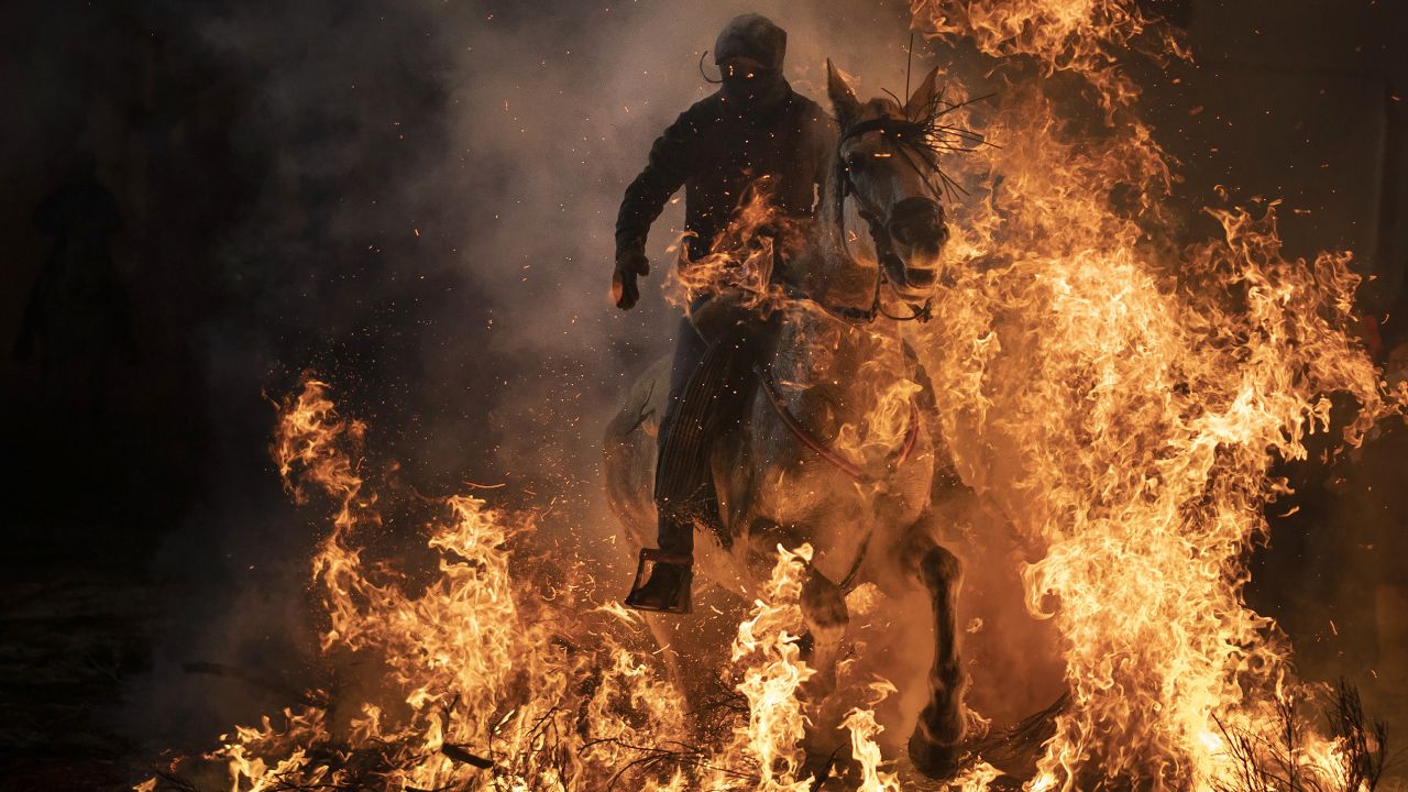 A man rides a horse through a bonfire as part of a ritual in honor of St. Anthony the Abbot, the patron saint of domestic animals, in Spain on Wednesday, January 16.