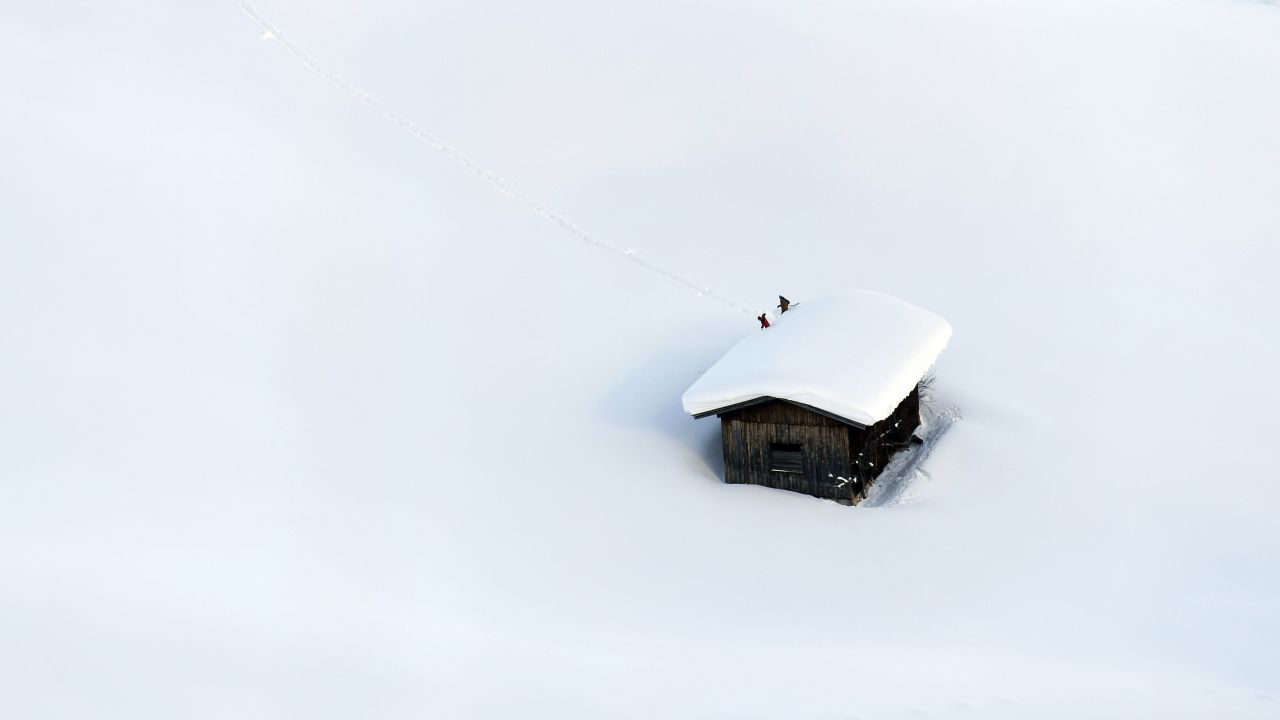People clear snow from a roof in Lofer, Austria, on Friday, January 11.