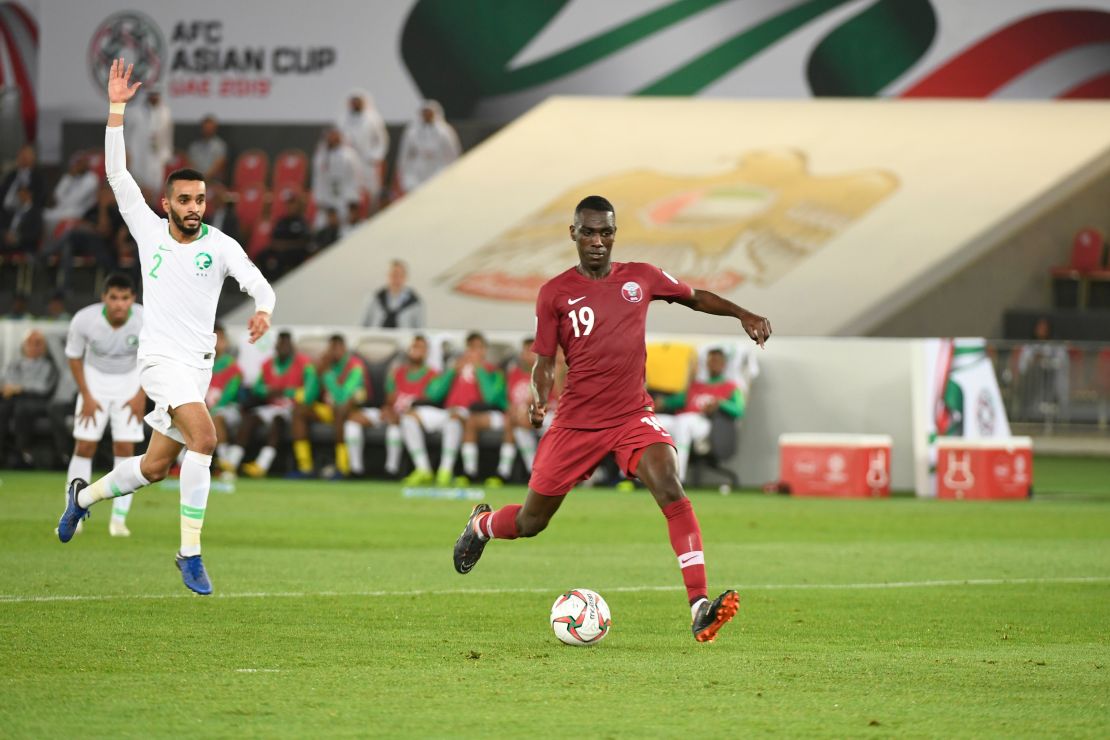 Qatar's forward Almoez Ali (R) fires home after escaping the Saudi backline.