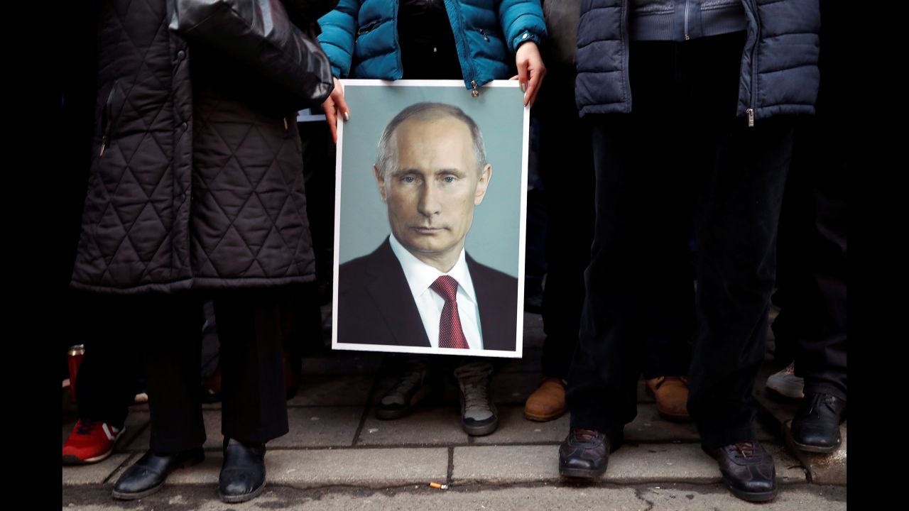 A supporter of Russian President Vladimir Putin holds his portrait in Belgrade, Serbia, on Thursday, January 17.