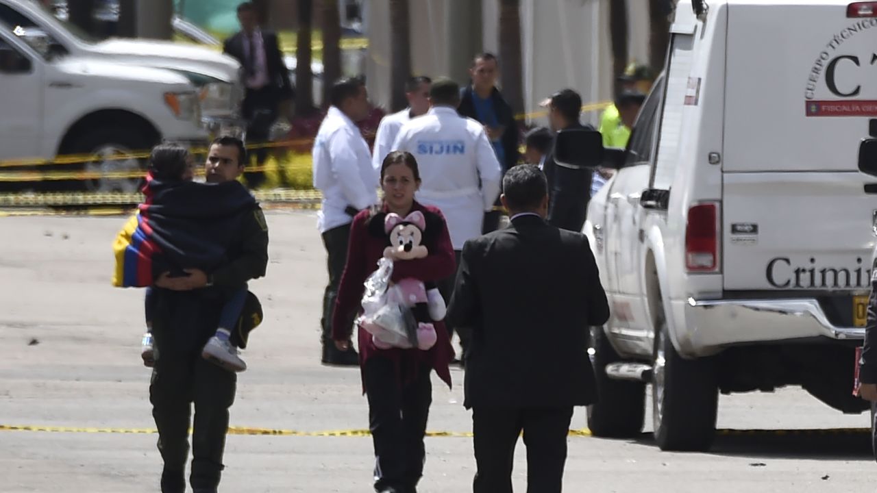 People evacuate after the blast near Bogota's Gen. Santander National Police Academy.
