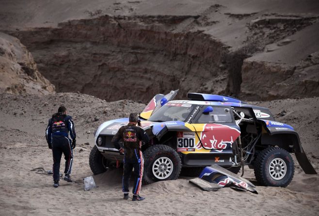 Carlos Sainz rings for help after a crash leaves his car heavily damaged.