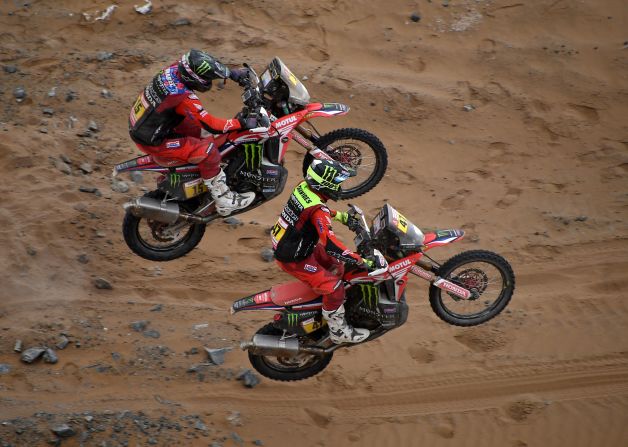 US biker Ricky Brabec and Argentina's Kevin Benavides do wheelies on sync during a stage-five battle between the pair.