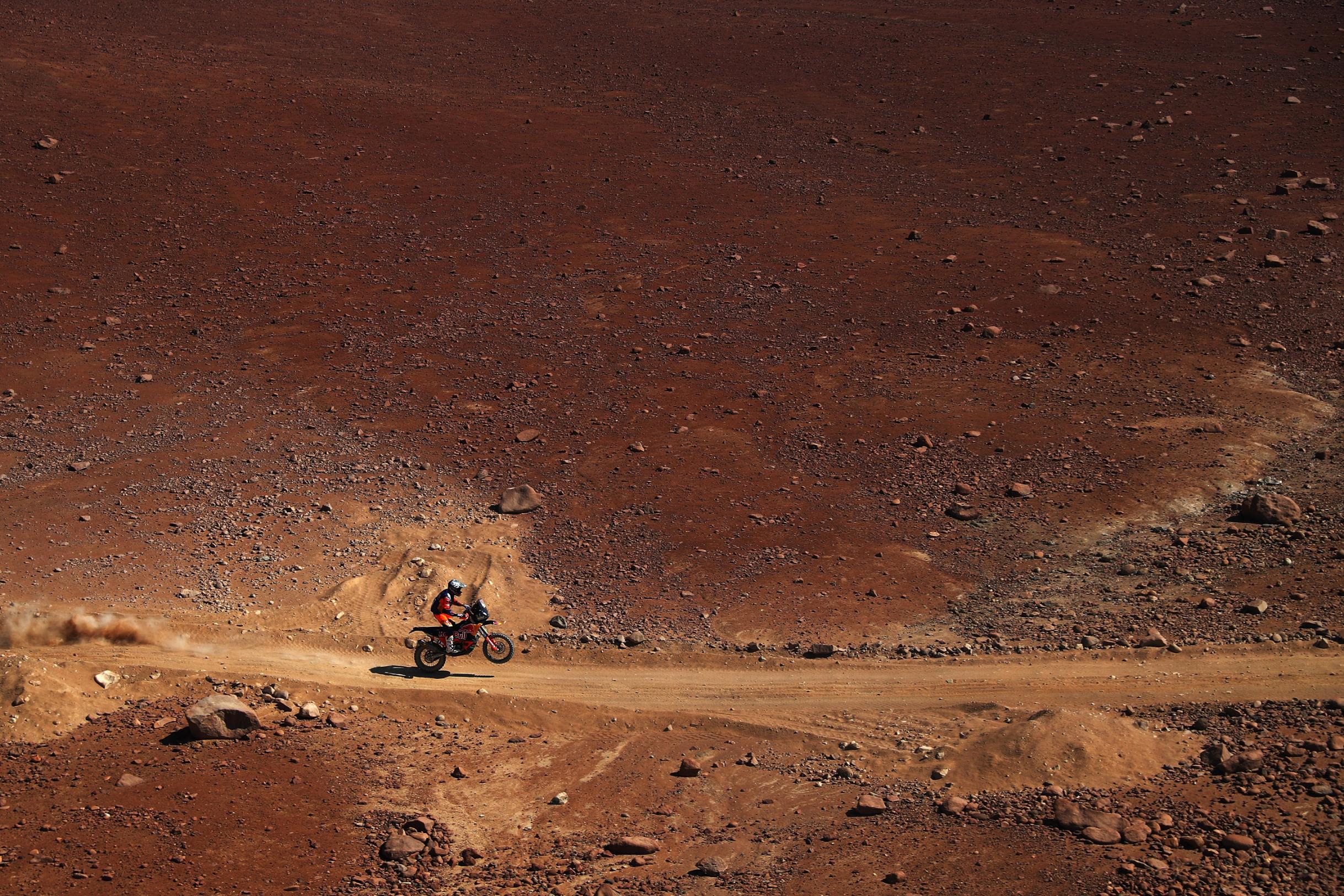 A red landscape acts as the backdrop as KTM rider Luciano Benavides tackles stage seven of the event.