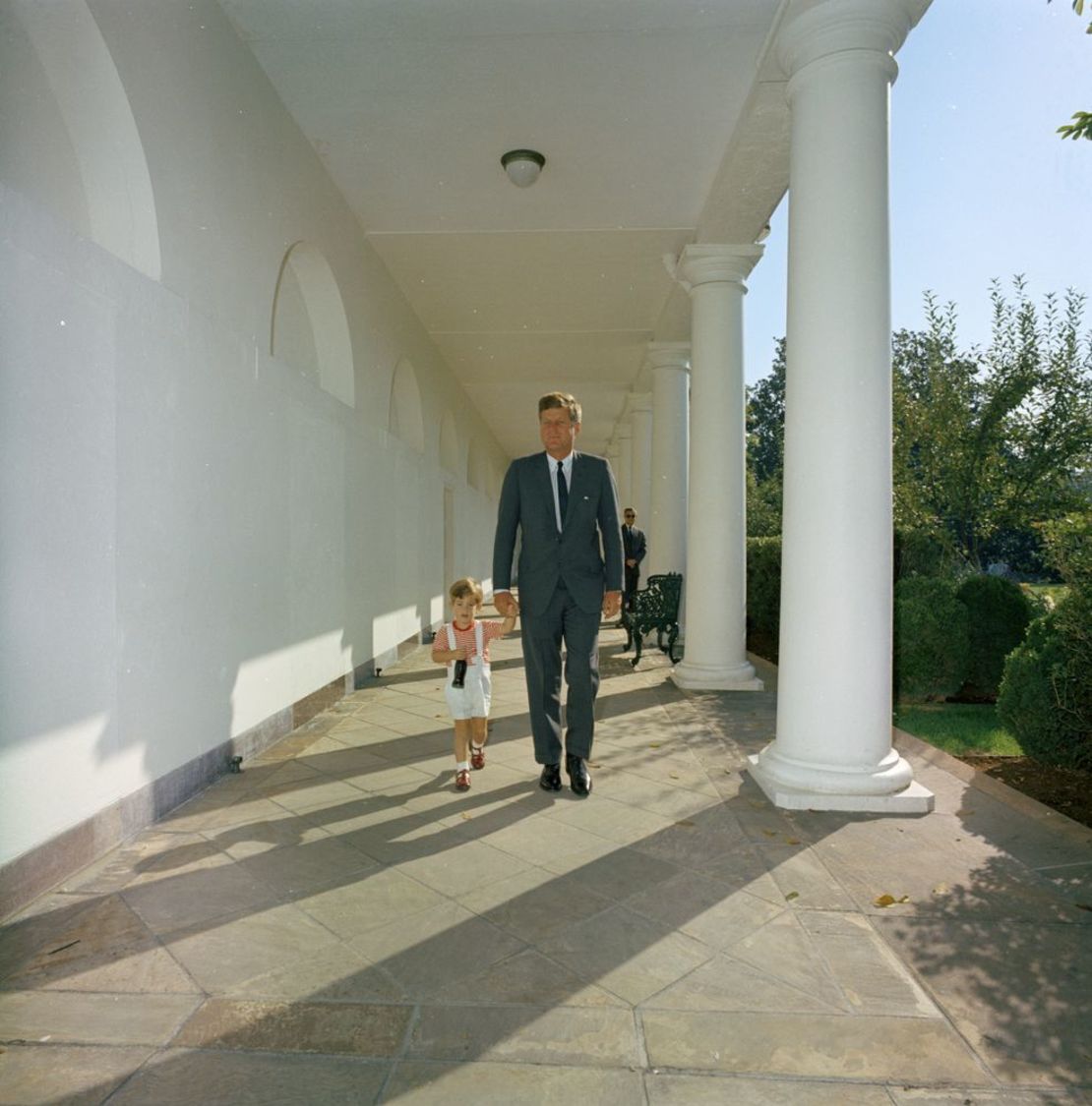 President John F. Kennedy walks with his son along the West Wing Colonnade of the White House, 19. Photo by Robert Knudsen.