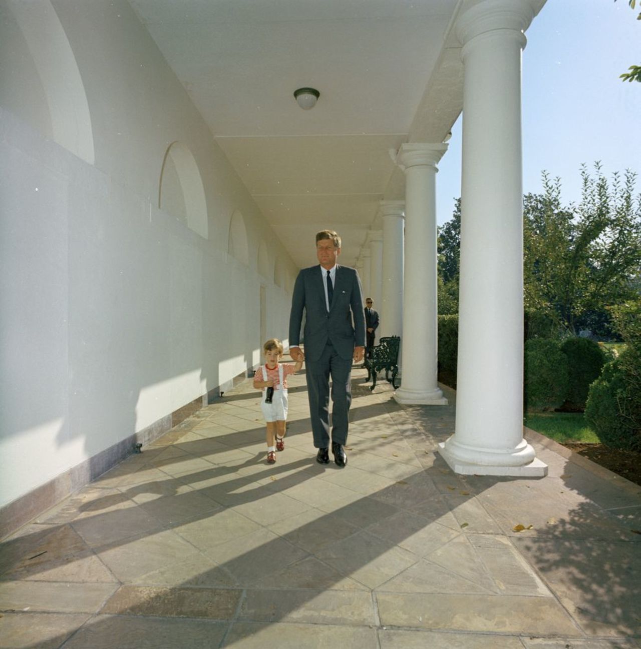 President John F. Kennedy walks with his son along the West Wing Colonnade of the White House, 19. Photo by Robert Knudsen. 