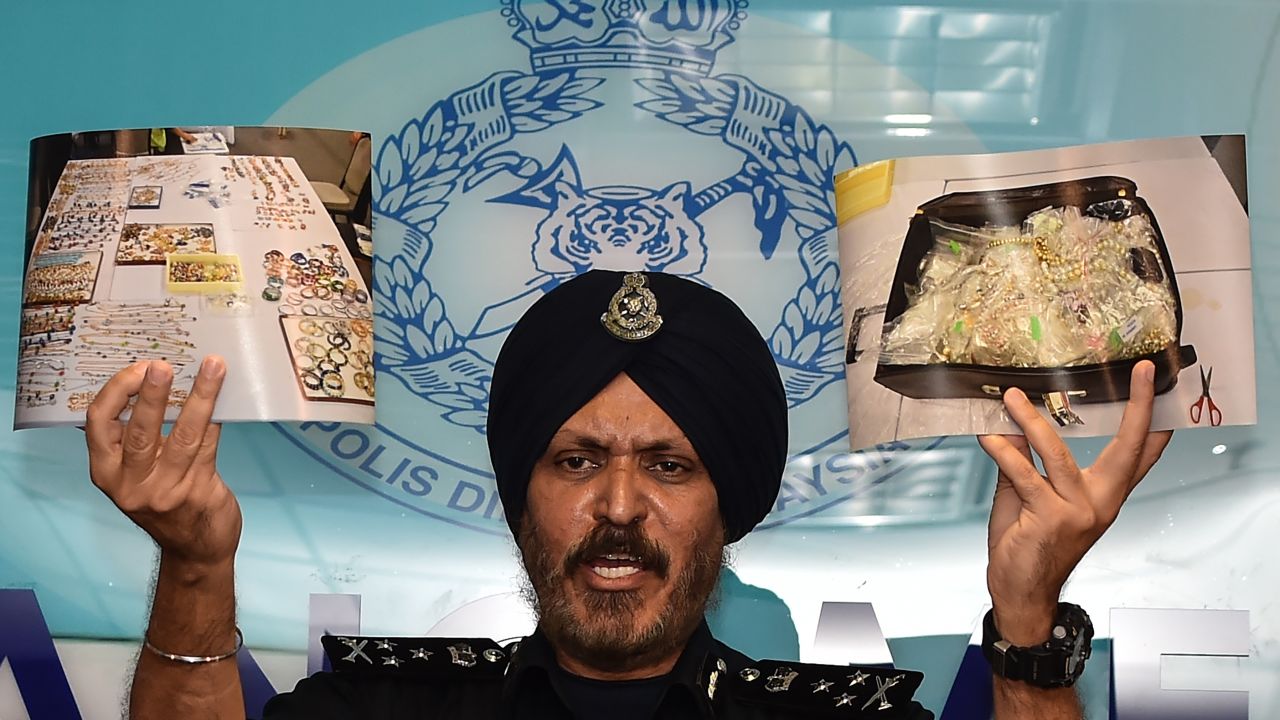 Malaysian police show photos of goods -- including millions of dollars worth of jewelry and hand bags -- seized from the home of former Prime Minister Najib Razak. 