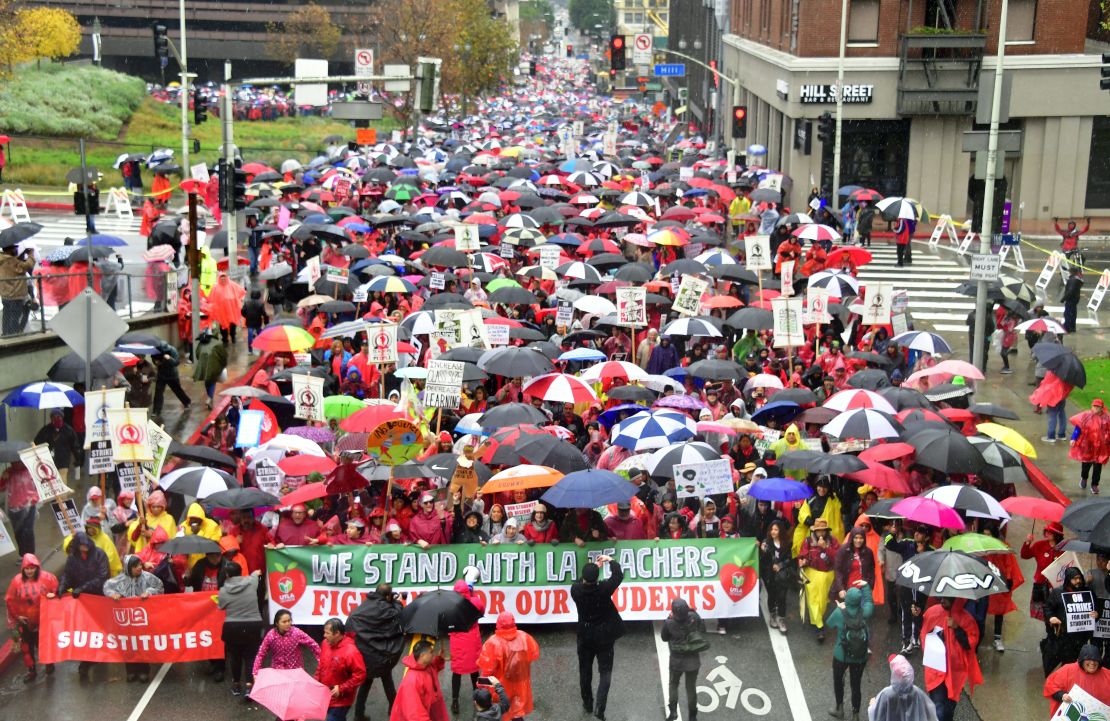 Thousands of teachers marched in the rain demanding more school staffing and higher salaries. 