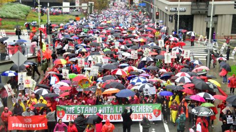 Thousands of teachers marched in the rain demanding more school staffing and higher salaries. 