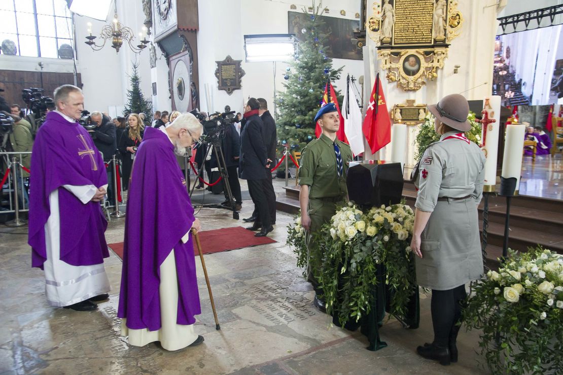 Catholic priests bow before the urn with ashes of slain Gdansk city Mayor Pawel Adamowicz at the start of his funeral in Gdansk on Saturday.