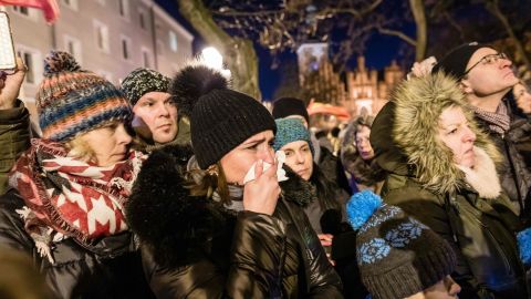 People mourn as the coffin of Pawel Adamowicz is taken from the European Solidarity Center to St Mary's Basilica on Friday.