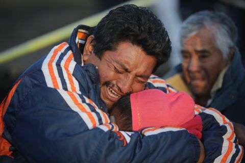 Relatives cry after recognizing the body of a loved one in the deadly pipeline blast on Saturday, January 19.