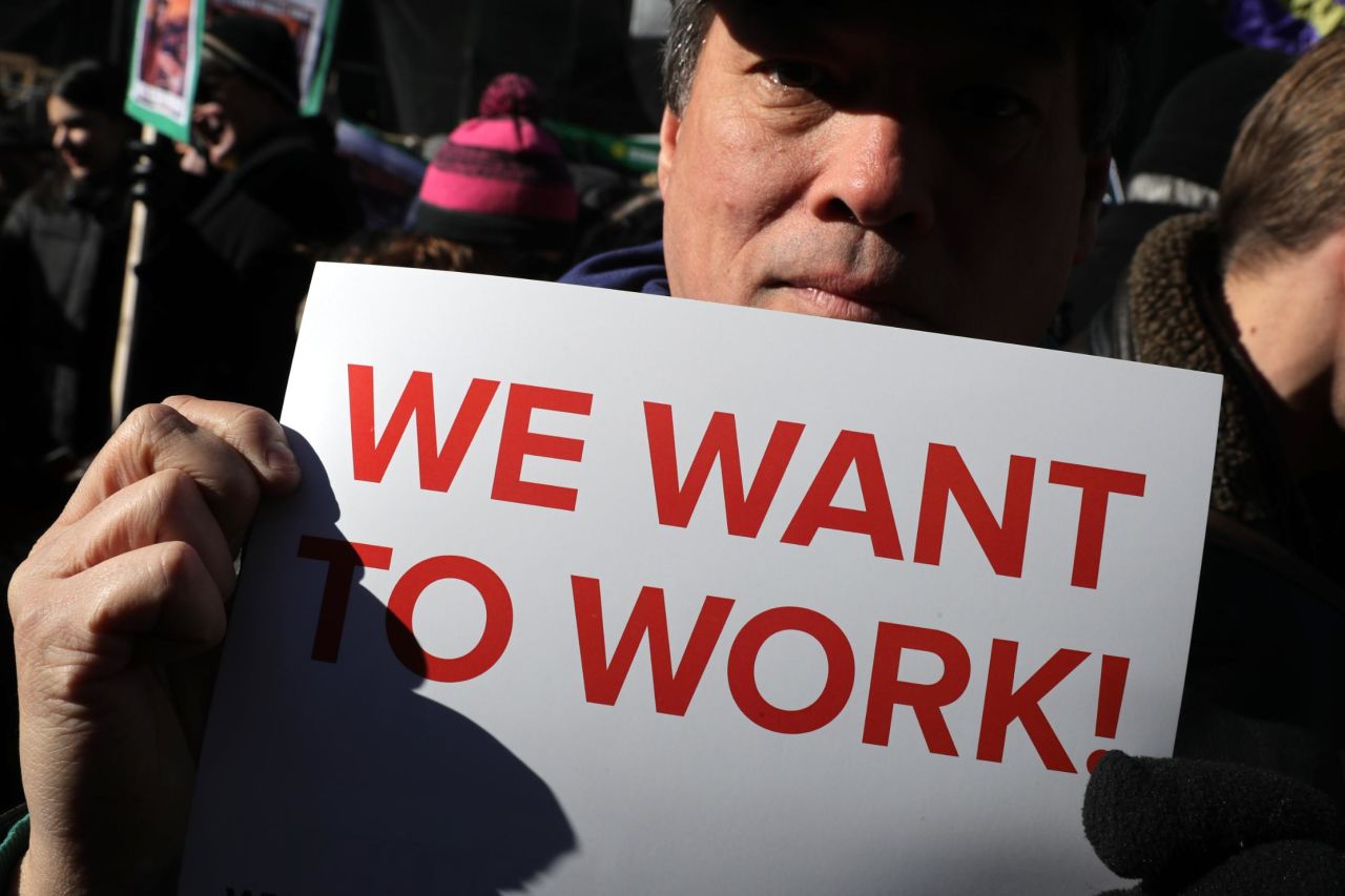 Federal workers and contractors rally against the government shutdown outside the AFL-CIO headquarters in Washington on Thursday, January 10.