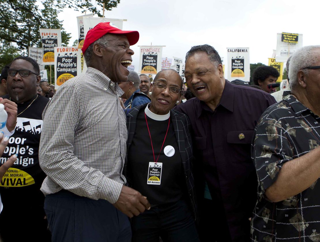 Actor Danny Glover, left, and the Rev. Jesse Jackson, right, march with others outside the US Capitol during the Poor People's Campaign rally in Washington on June 23, 2018.