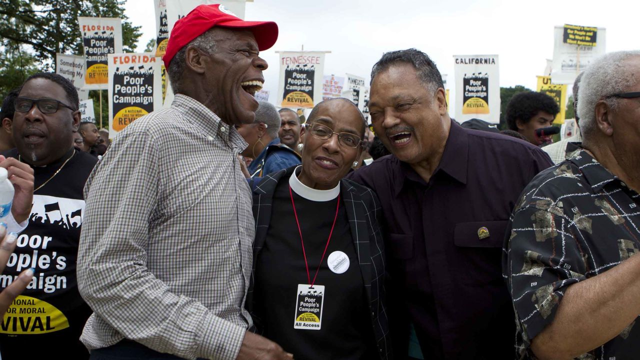 Actor Danny Glover, left, and the Rev. Jesse Jackson, right, march with others outside the US Capitol during the Poor People's Campaign rally in Washington on June 23, 2018.
