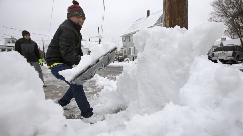 Miguel Delao, of Norwood, Mass., front, shovels snow in front of his home, Sunday, Jan. 20, 2019, in Norwood. A major winter storm that blanketed most of the Midwest with snow earlier in the weekend barreled toward New England Sunday, where it was expected to cause transportation havoc ranging from slick and clogged roads to hundreds of cancelled airline flights. (AP Photo/Steven Senne)