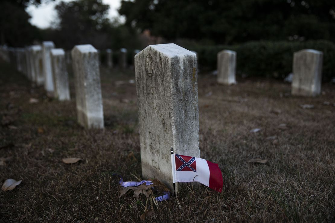 A Confederate flag adorns the grave of a Confederate soldier in Oakland Cemetery.