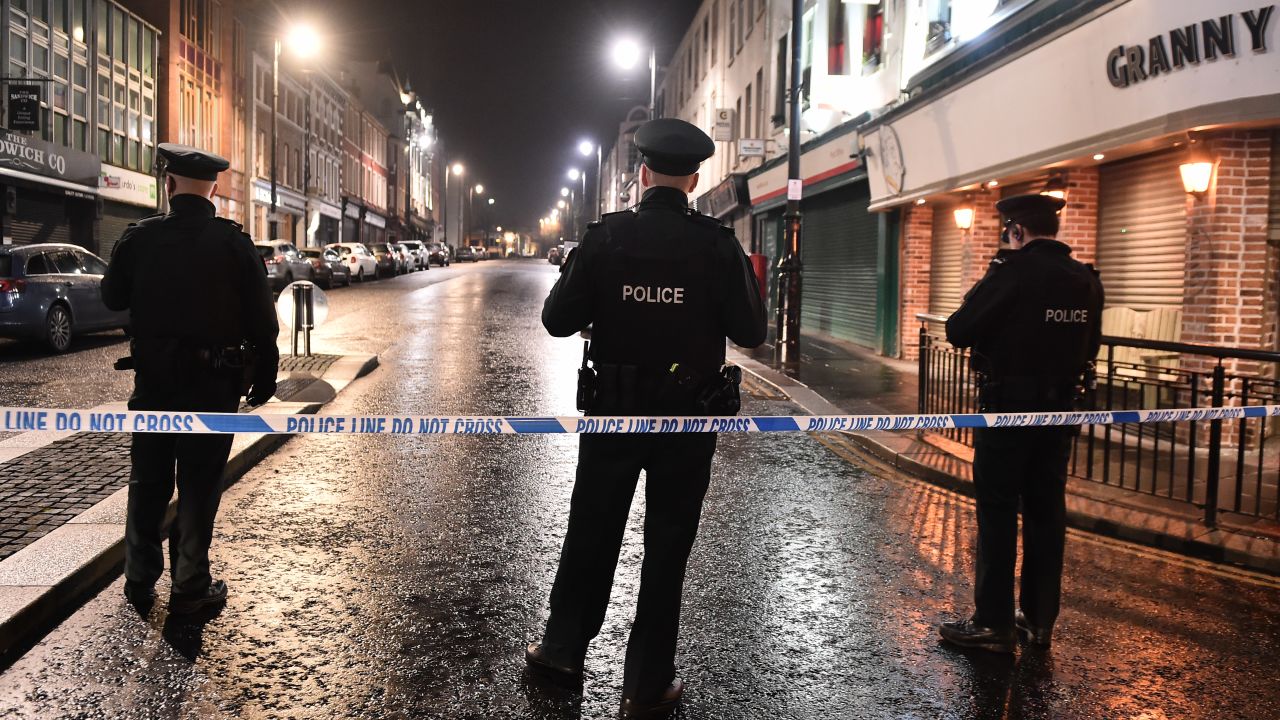 LONDONDERRY, NORTHERN IRELAND - JANUARY 19: PSNI officers stand watch over the remains of the car that was earlier hijacked and packed with explosives before being detonated outside Derry court house on January 19, 2019 in Londonderry, Northern Ireland. Dissident republicans are suspected to be behind the attack. (Photo by Charles McQuillan/Getty Images)