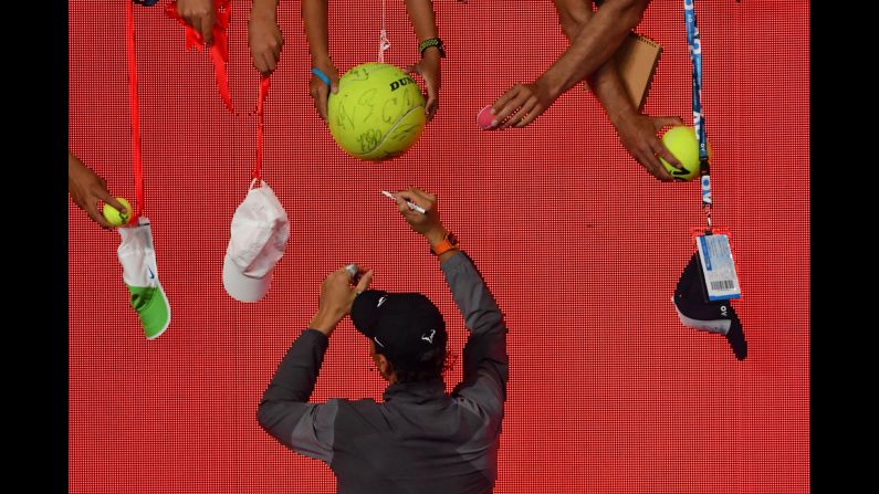 Tennis star Rafael Nadal signs autographs after his victory over Matthew Ebden during their men's singles match on the third day of the Australian Open on Wednesday, January 16.