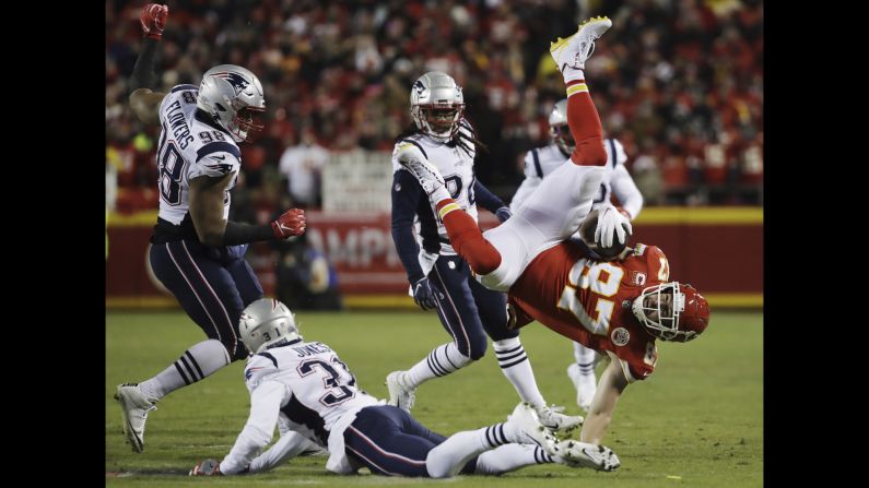 Kansas City Chiefs tight end Travis Kelce flips as he is tackled by New England Patriots defensive back Jonathan Jones during the first half of the AFC Championship game on Sunday, January 20.