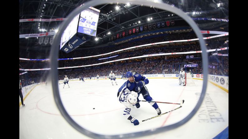 Tampa Bay Lightning left wing Alex Killorn, right, checks Toronto Maple Leafs defenseman Travis Dermott during the second period at Amalie Arena in Florida on Thursday, January 17.