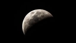 The moon nears total eclipse Sunday as the Earth casts a shadow on the lunar surface.