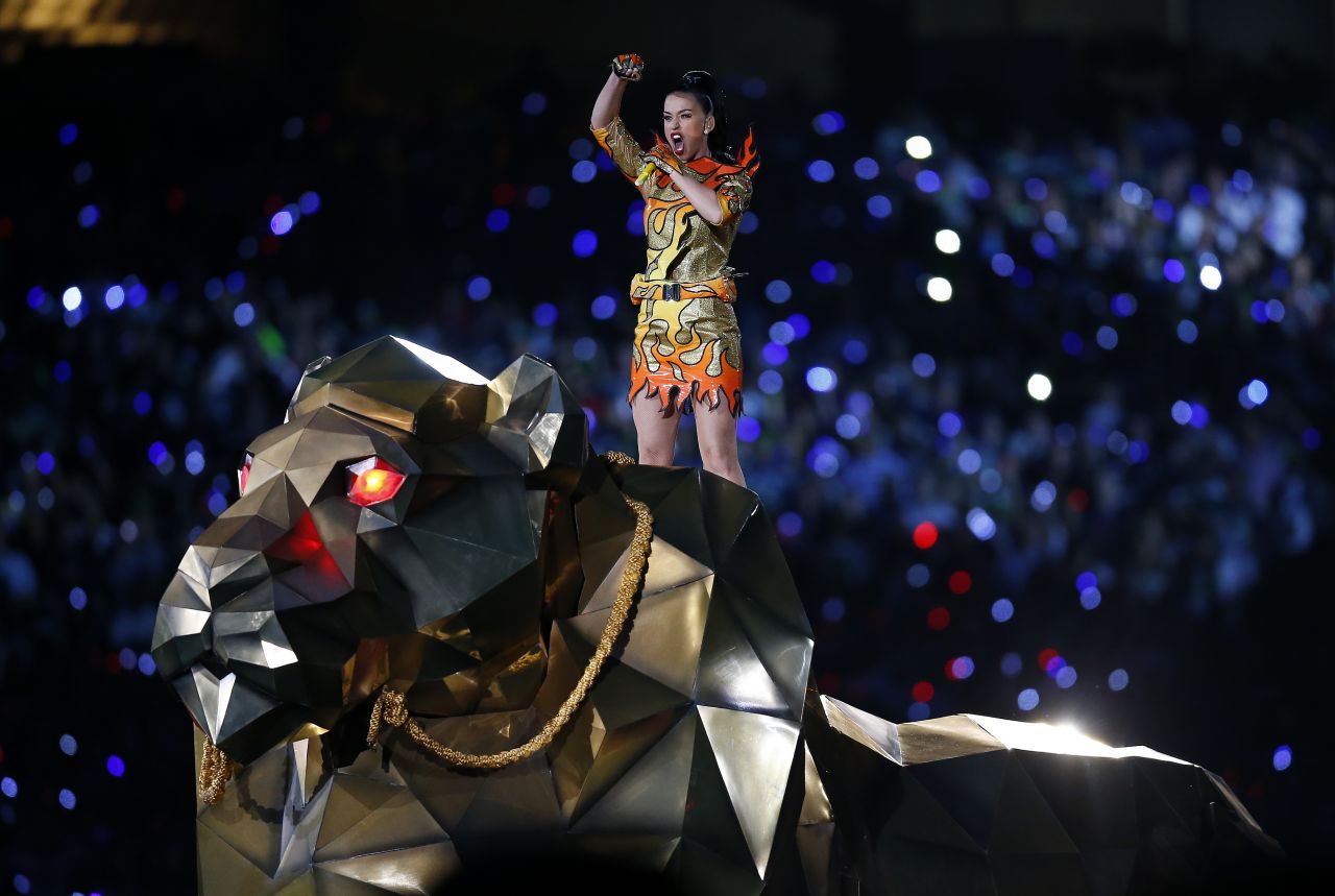 Katy Perry, wearing Jeremy Scott, performs her single "Roar" atop a metal lion during the Super Bowl XLIX halftime show.