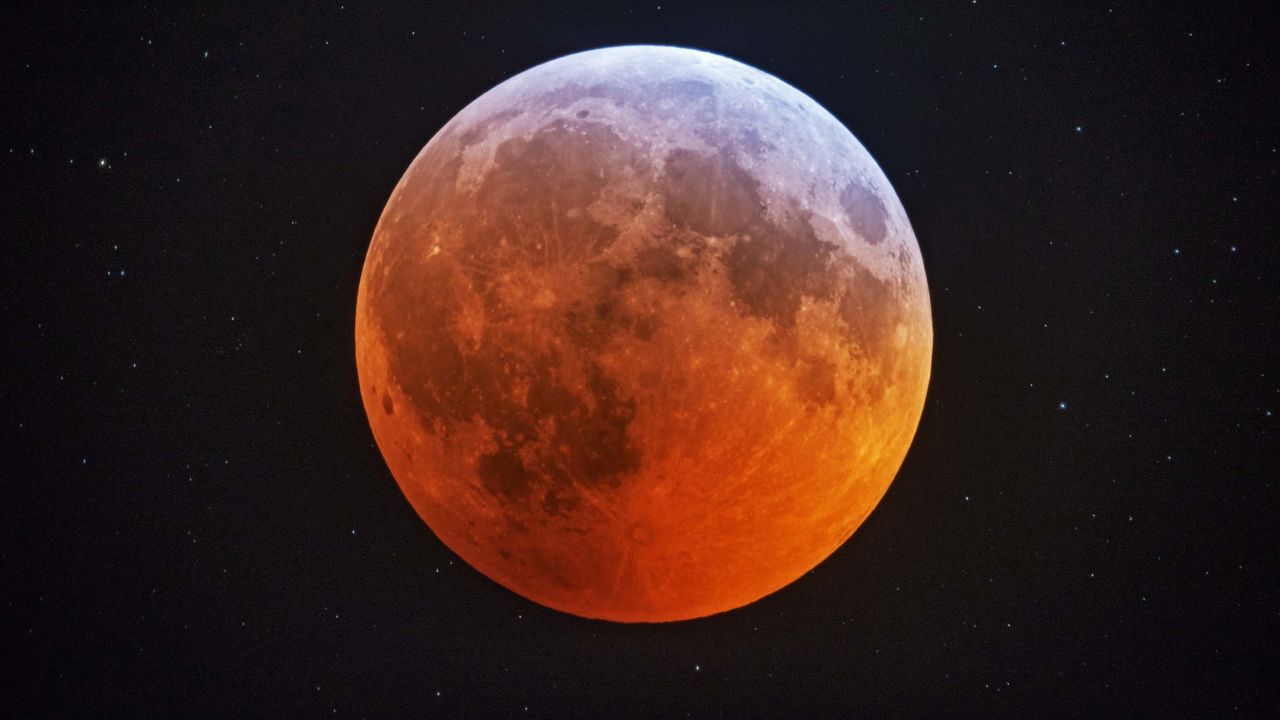 In this photo made with a 12-1/2 inch telescope and provided by Johnny Horne, the totally eclipsed moon glows with a reddish color against the background stars over Stedman, N.C., Monday, Jan. 21, 2019. It was also the year's first supermoon, when a full moon appears a little bigger and brighter thanks to its slightly closer position. During totality, the moon will look red because of sunlight scattering off Earth's atmosphere. That's why an eclipsed moon is sometimes known as a blood moon. In January, the full moon is also sometimes known as the wolf moon or great spirit moon. (Johnny Horne via AP)