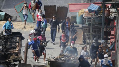 Anti-government protesters clash with security forces Monday in the Cotiza neighborhood of Caracas.