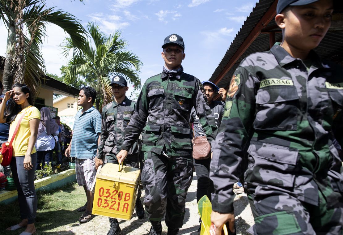 A policeman carries a ballot box at a voting precinct in Cotabato on the southern Philippine island of Mindanao on January 21, 2019, during a vote on giving the nation's Muslim minority greater control over the region.