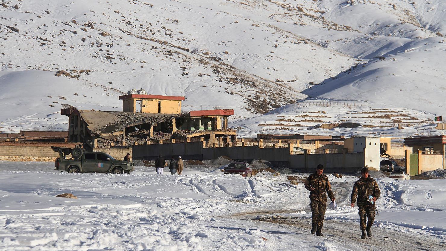 Afghan security forces walks near a site after a car bomb attack on a military base in the central province of Maidan Wardak on January 21, 2019.  